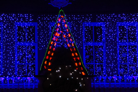 Close-up of house decorated and lighted for Christmas and for New Year Eve at nightの写真素材