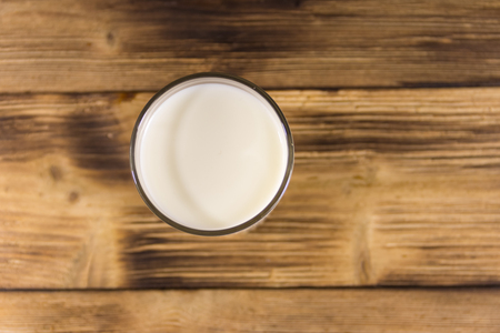 Glass of milk on wooden table. Top viewの写真素材
