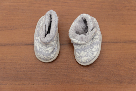 Baby booties on wooden backgroundの写真素材