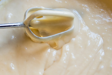 Raw dough with whisk in bowl close-upの写真素材