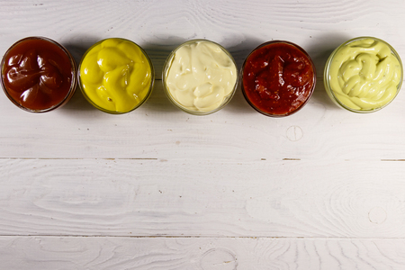 Set of sauces on white wooden table. Top view, copy spaceの写真素材