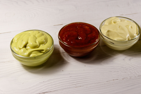 Set of sauces on white wooden tableの写真素材