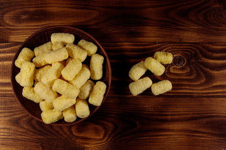 Sweet corn sticks on a plate on wooden table. Top viewの写真素材