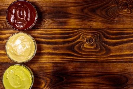 Set of sauces on wooden table. Top view, copy spaceの写真素材