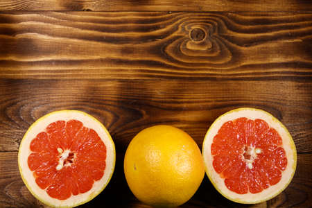 Ripe fresh grapefruits on wooden table. Top view, copy spaceの写真素材