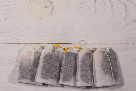 Tea bags on white wooden table. Top viewの写真素材