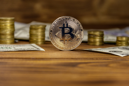 Silver bitcoin and dollars on wooden backgroundの写真素材