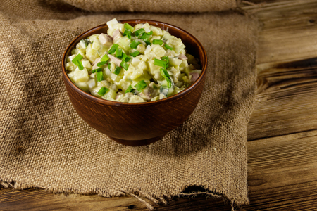 Traditional Russian festive salad Olivier on wooden tableの写真素材