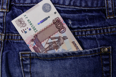 Five hundred russian rubles banknote in the pocket of blue jeans