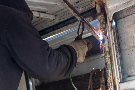 Worker welding the steel part by manual