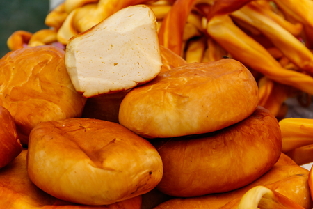 Different kinds of smoked cheese on a tableの写真素材