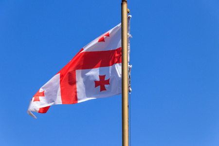 Georgian flag against blue skyの写真素材