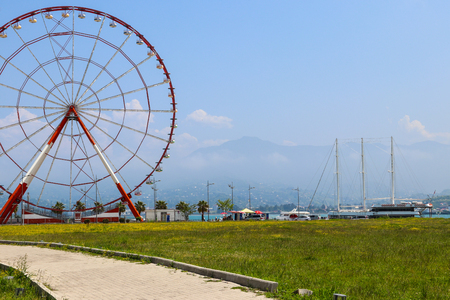 Batumi, Adjara, Georgia - May 3, 2018: Ferris wheel on embankment of Batumi at sunny dayのeditorial素材