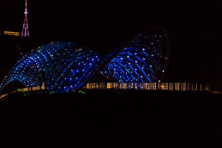 Bridge of Peace in Tbilisi. Pedestrian bridge over the Kura river at night