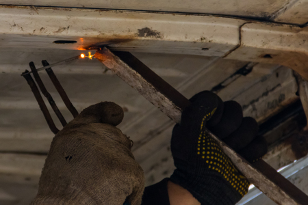 Worker welding the steel part by manual