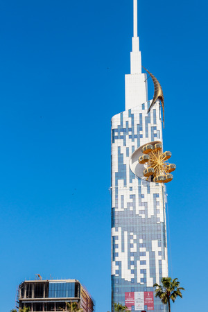 Batumi, Adjara, Georgia - May 3, 2018: Technological University skyscraper tower with golden Ferris wheel. It is the first ever skyscraper in the world with an integrated Ferris wheelのeditorial素材