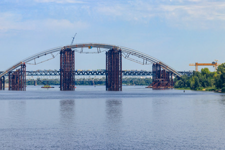 Podilsko-Voskresenskyi Bridge or Podilskyi Metro Bridge is a combined road-rail bridge over the Dnieper River under construction in Kiev, Ukraineの写真素材