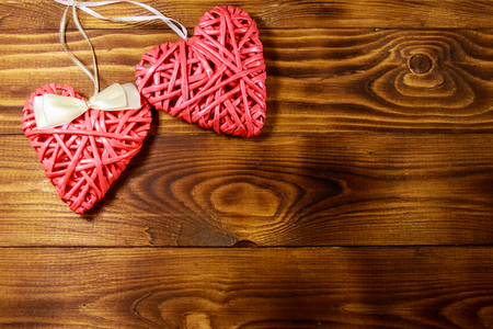 Two pink hearts on wooden background. Top view, copy spaceの写真素材