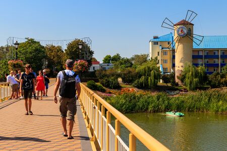 Myrhorod, Ukraine - August 26, 2018: Unknown people walking on pedestrian bridge across Khorol river in wellness resort Myrhorodのeditorial素材