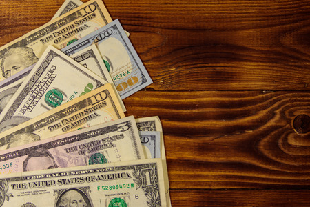 American dollars on wooden background. Top view, copy spaceの写真素材