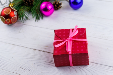Gift box and Christmas decorations on white wooden tableの写真素材
