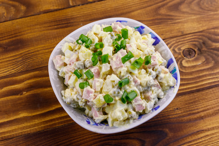Traditional Russian festive salad Olivier on wooden table. Top viewの写真素材