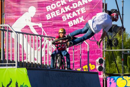 Kremenchug, Ukraine - June 5, 2017:  Extreme BMX rider in helmet in skatepark on competition. Unidentified BMX rider making tricks on festival Extreme zoneのeditorial素材