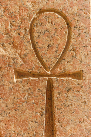 Ancient egyptian hieroglyphic symbol Ankh ("Key of Life", "Eternal Life", "Egyptian Cross") carved on the stoneの写真素材