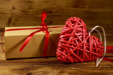 Gift box and red heart on wooden background. Valentine's day conceptの写真素材