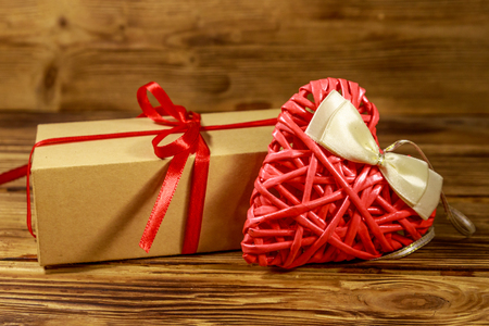 Gift box and red heart on wooden background. Valentine's day conceptの写真素材