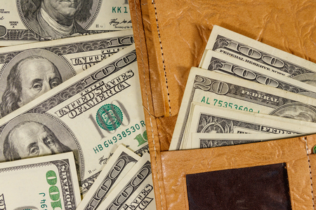 Opened wallet on the american one hundred dollar bills backgroundの写真素材
