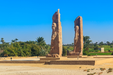 Recently raised quartzite Colossi of Amenhotep III at the Northern Gate of the temple of Luxor, Egyptの写真素材