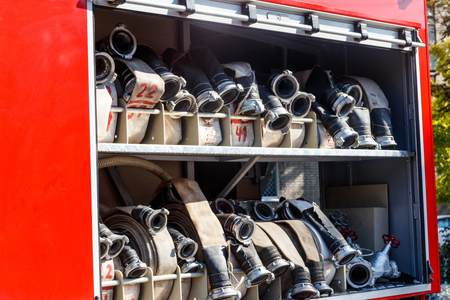 Rescue fire truck equipment. Compartment of the rolled up fire hoses on a fire engine