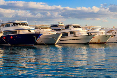 White yachts in the sea harbor of Hurghada, Egypt. Port with tourist boats on the Red Sea