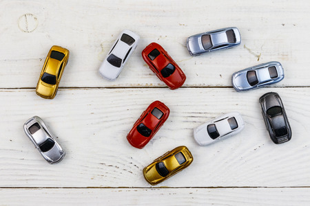 Cars toys on white wooden background. Top view