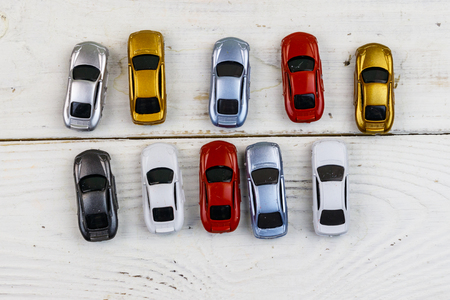Cars toys on white wooden background. Top viewの写真素材