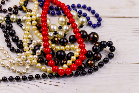 Different beads necklaces on white wooden backgroundの写真素材