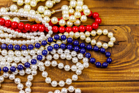 Different beads necklaces on wooden backgroundの写真素材