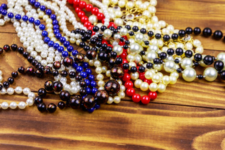 Different beads necklaces on wooden backgroundの写真素材