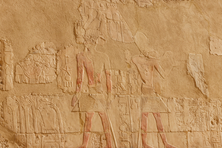 Ancient egyptian paintings and hieroglyphs on a wall in Mortuary temple of Hatshepsut in Luxor,...
