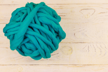 Merino wool yarn ball on white wooden background. Top viewの写真素材