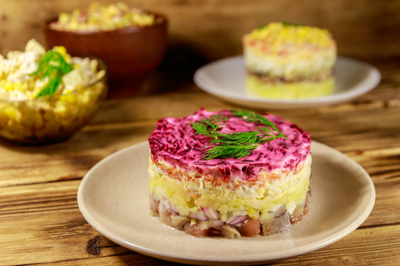 Set of festive mayonnaise salads on wooden tableの写真素材