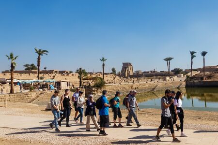 Luxor, Egypt - December 11, 2018: Group of tourist walking near sacred lake in Karnak Temple Complex in Luxor, Egyptのeditorial素材