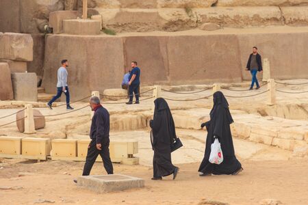 Cairo, Egypt - December 8, 2018: Arab with his two wives walking near Great pyramids of Giza in Cairo, Egyptのeditorial素材