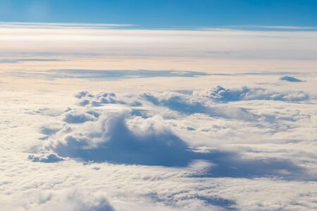 Beautiful white clouds in blue sky. View from airplaneの写真素材