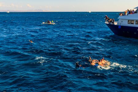 Hurghada, Egypt - December 7, 2018: Unknown people snorkeling over the coral reef and resting on yachts in the Red Seaのeditorial素材