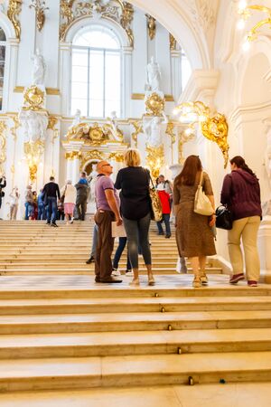 St. Petersburg, Russia - June 26, 2019: Tourists walk up the steps of the Jordan staircase in the...