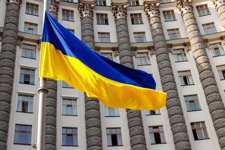 Flag of Ukraine against the Cabinet of Ministers of Ukraine buildingの写真素材