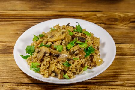 Tasty risotto with mushrooms on wooden tableの写真素材