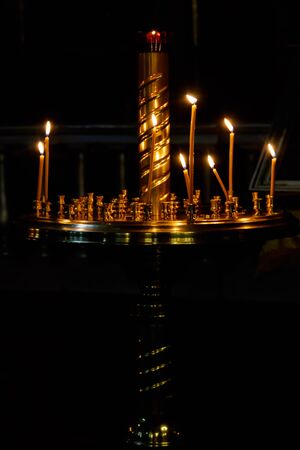 Large church golden candlestick with burning candles in orthodox churchの写真素材